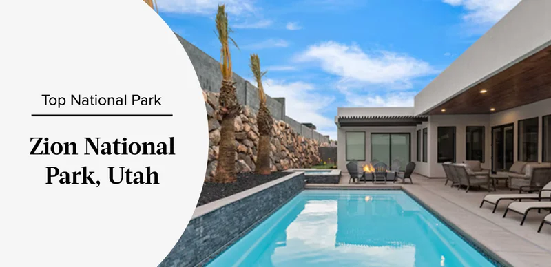 Modern home with pool and lounge chairs set against rocky landscaping under a blue sky.