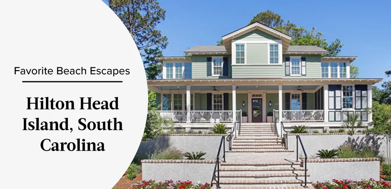 Large coastal-style house with green siding, white trim, and a wide front porch.