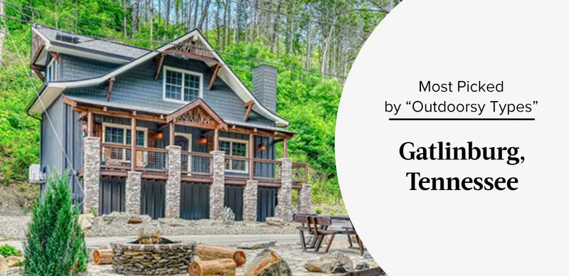 Rustic cabin with stone pillars and wooden balcony surrounded by lush green forest.