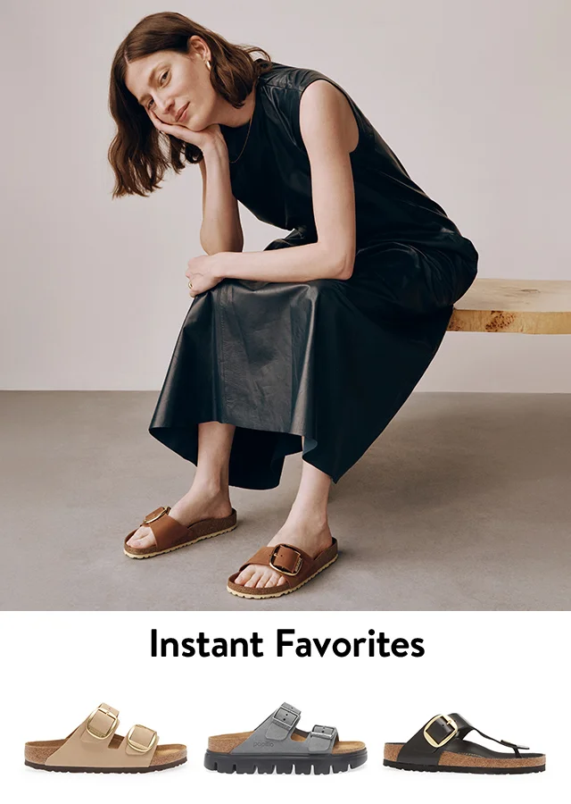 A woman wearing brown Birkenstock slides with a black dress. Tan, grey and black Birkenstock sandals.