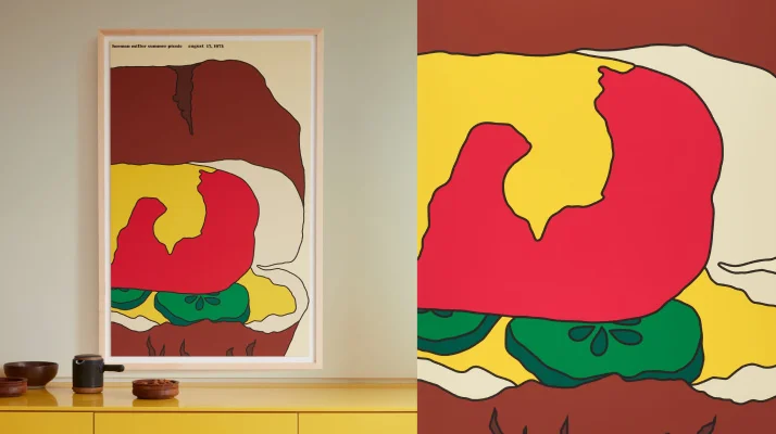 A graphic poster of part of a hot dog with toppings hanging vertically on a wall above a bright yellow cabinet with wooden accessories sitting on top.