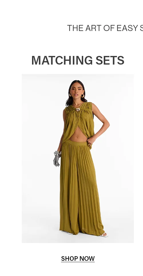 Pleated matching set in olive green: draped sleeveless top with V-neck & buckle, wide-leg pants. Women's two-piece outfit.