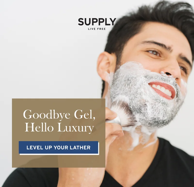 Man lathering up shaving cream with shave brush