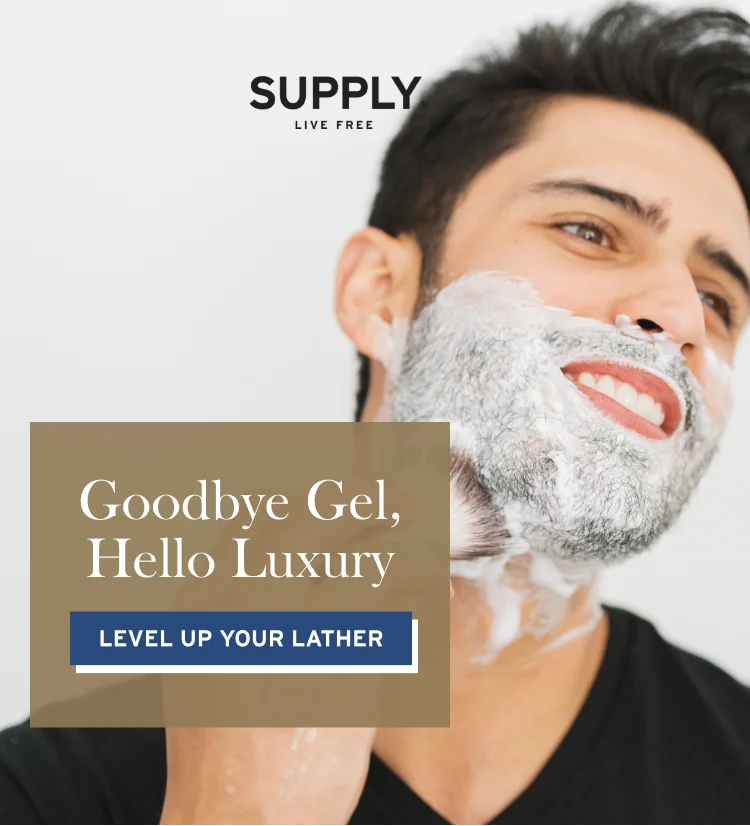 Man lathering shaving cream with shave brush