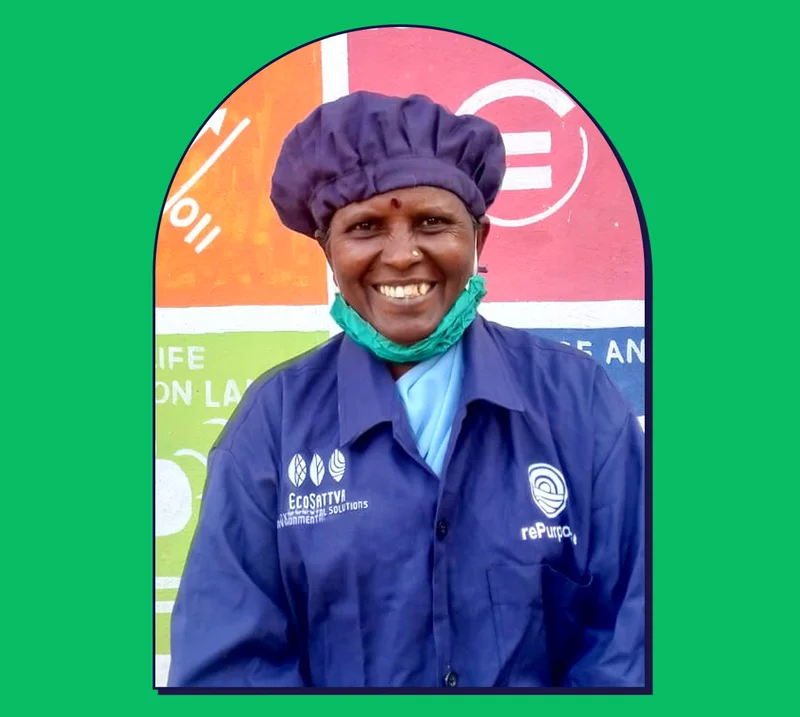 Image of worker in uniform against a colorful mural