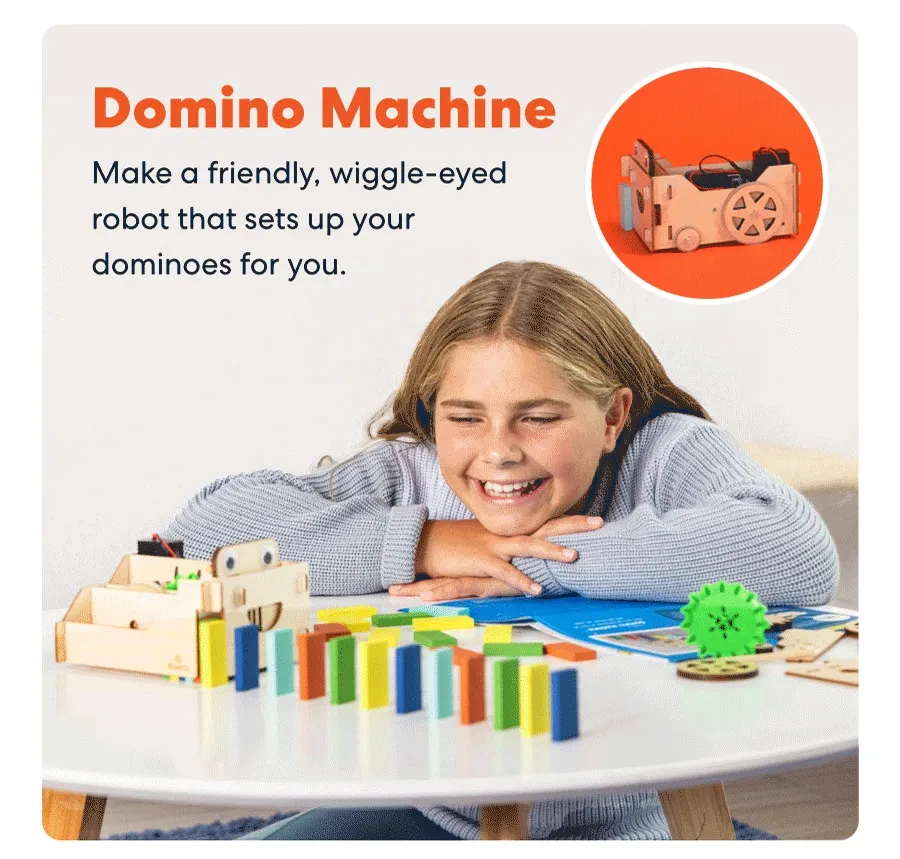 Smiling child playing with a colorful domino-setting robot that helps line up dominoes automatically.