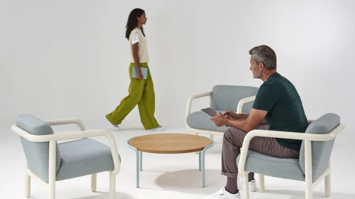 White background shot of people interacting with Percy lounge chair.