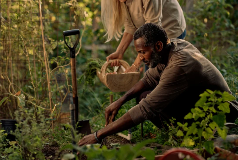 Two people gardening outdoors wearing Oura Ring