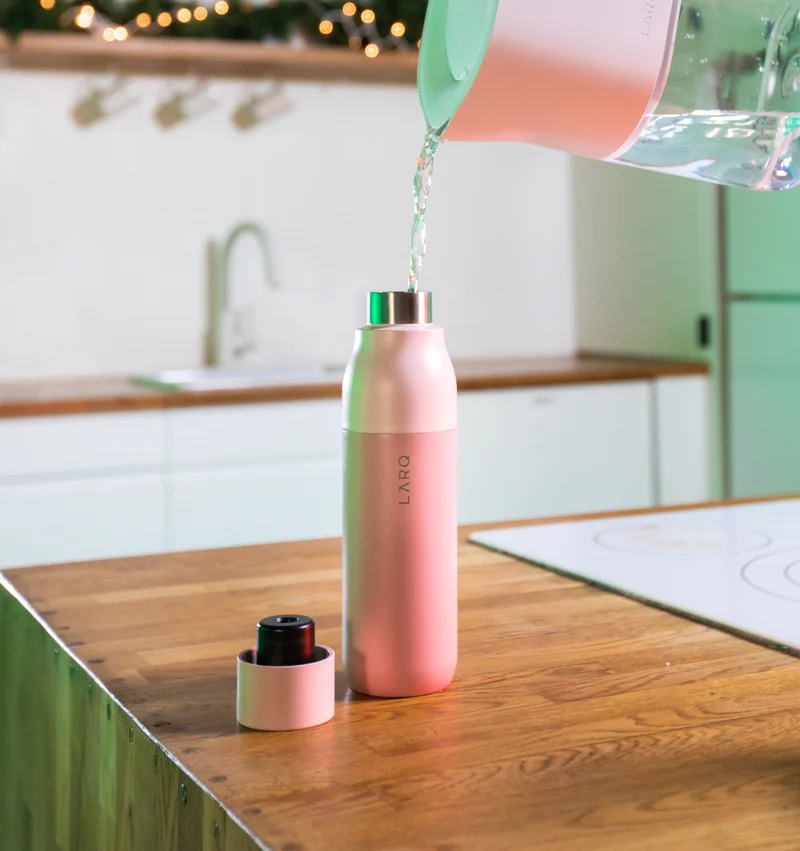 LARQ Pitcher PureVis™ pouring water into LARQ Bottle PureVis™ - Himalayan Pink