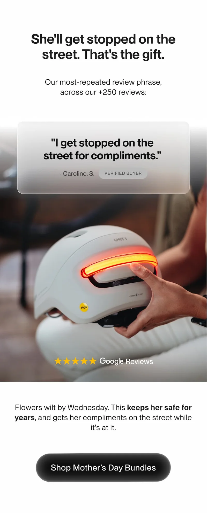 Hand holding a white UNIT 1 bike helmet with red rear light, 5-star Google Reviews, Shop Mother's Day Bundles CTA