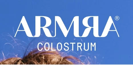 ARMRA Colostrum logo in white on a blue background.