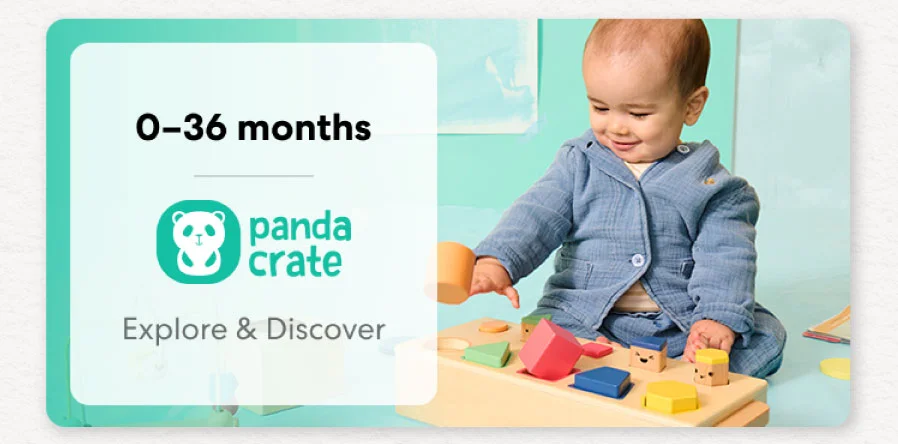 Baby smiling while working on creative KiwiCo Panda Crate projects, perfect for ages 0-36 months for play and learn.