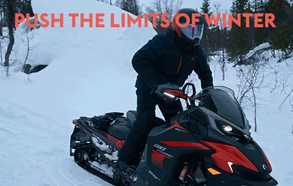 A person riding a Ski-Doo snowmobile