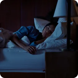 Person laying in bed wearing Oura Ring