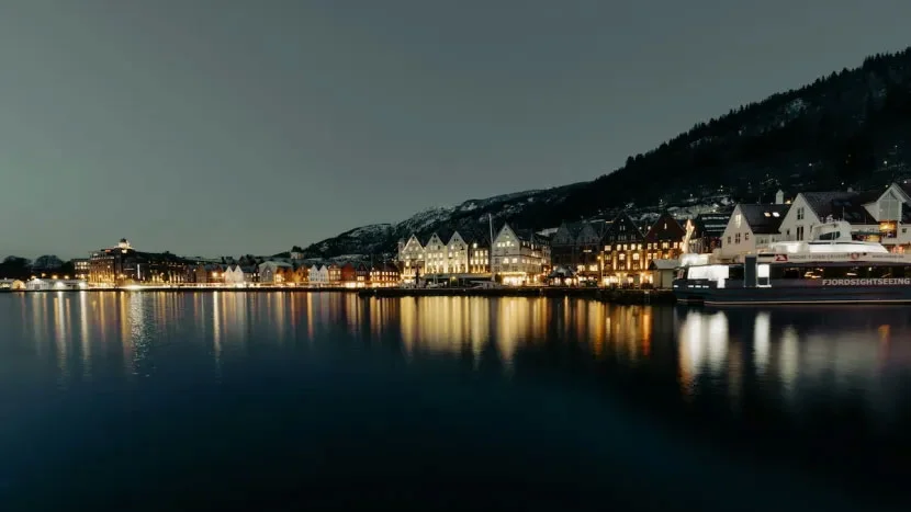 houses over a dark lake at dusk