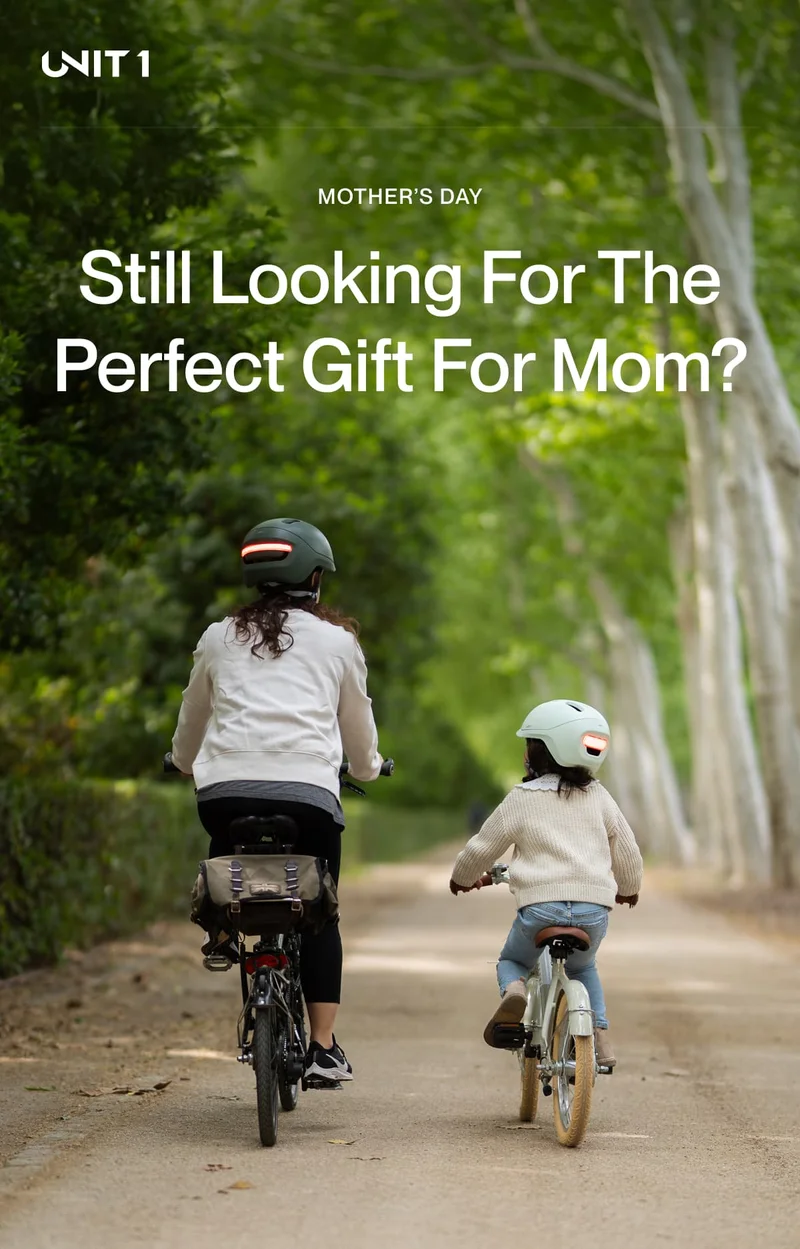Mom and daughter riding bikes together, both wearing UNIT 1 smart helmets — a perfect Mother’s Day gift that keeps her safe.