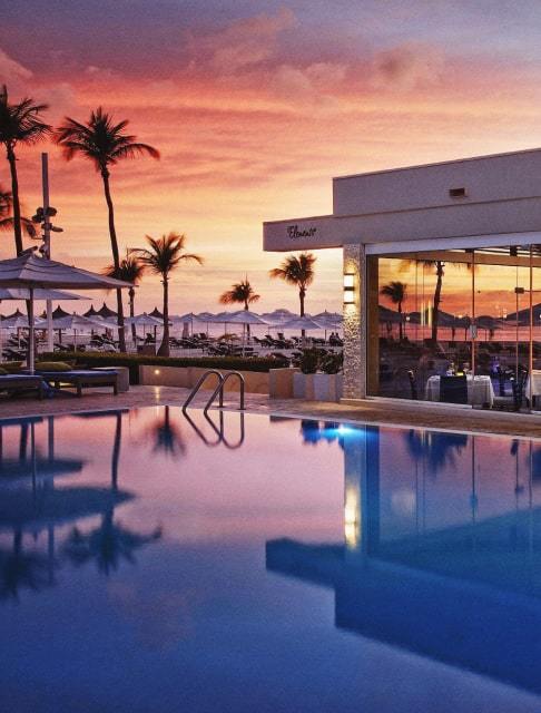 Image Description: Landscape shot of a luxurious poolside restaurant at Bucuti & Tara Beach Resort in Aruba