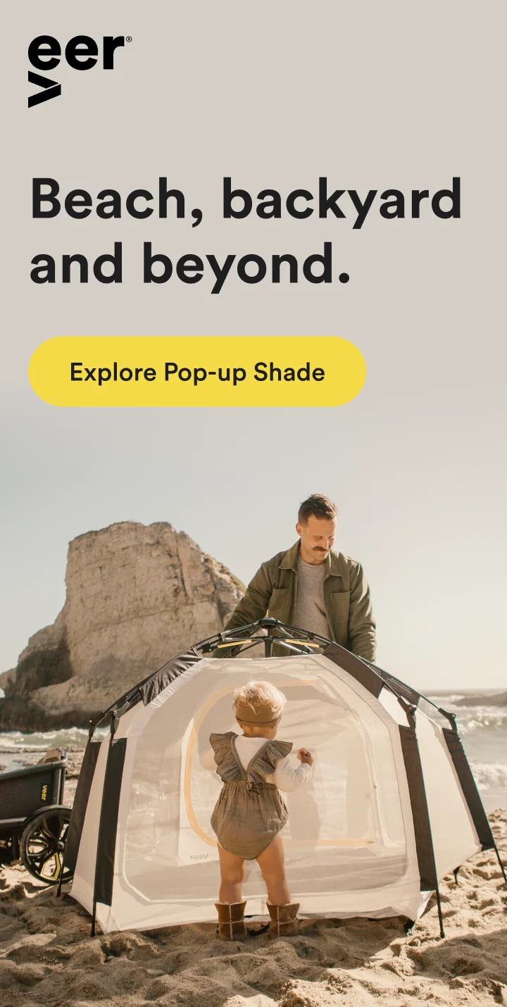 A father setting up the Basecamp on the beach