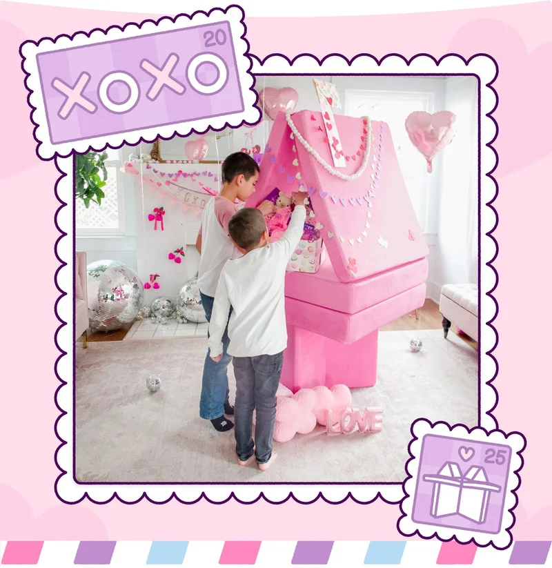 Two children add gifts to their Valentine's day mailbox build