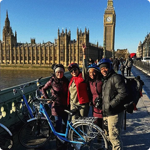 Image Descriptions: A dinosaur fossil exhibit at a museum and an image of four people smiling next to a bike with Big Ben in the background.