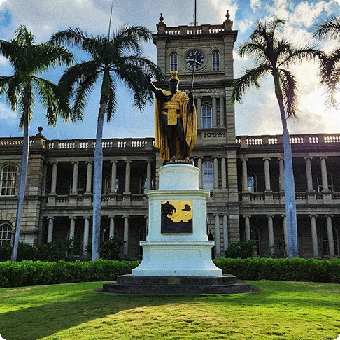Image Descriptions: A historical building with a statue in front surrounded by palm trees and an image of two people snorkeling.