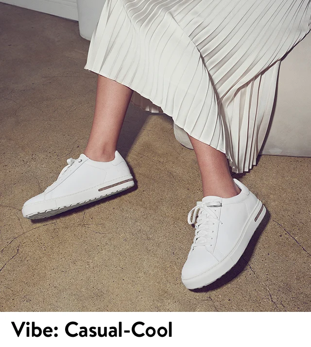 Woman wearing white Birkenstock sneakers.