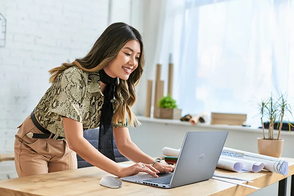 Smiling Designer Working on Laptop in Studio