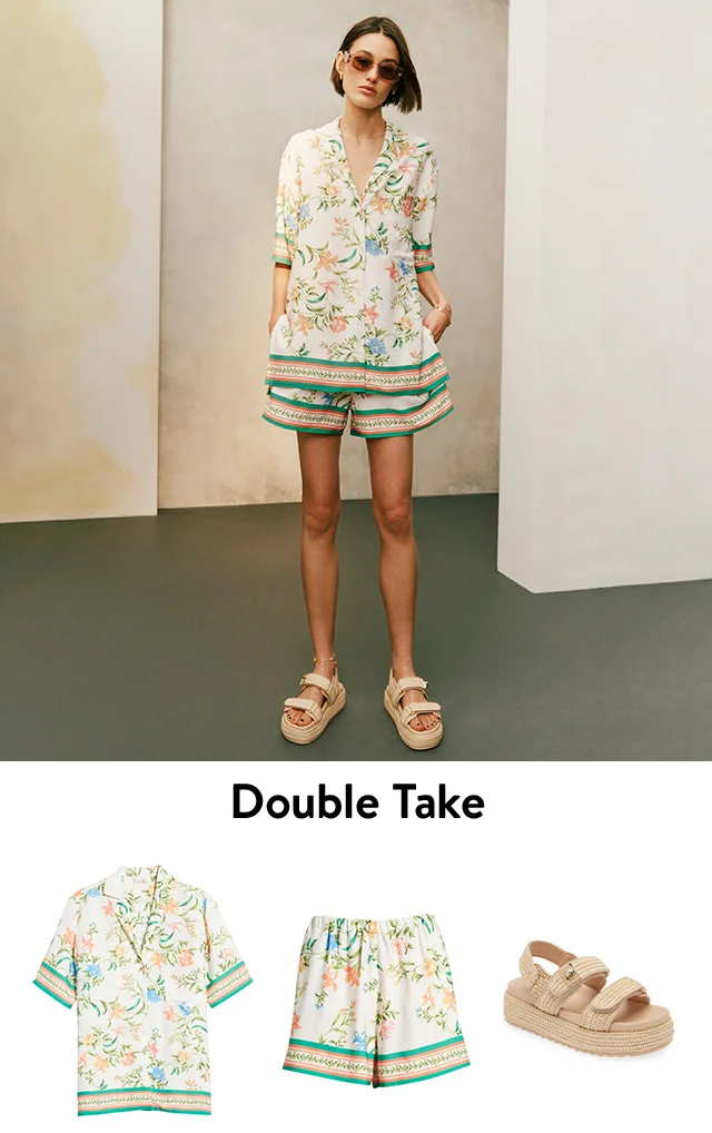 A woman wearing a floral camp shirt with matching shorts and raffia platform sandals. A floral camp shirt, matching floral shorts and raffia platform sandals.