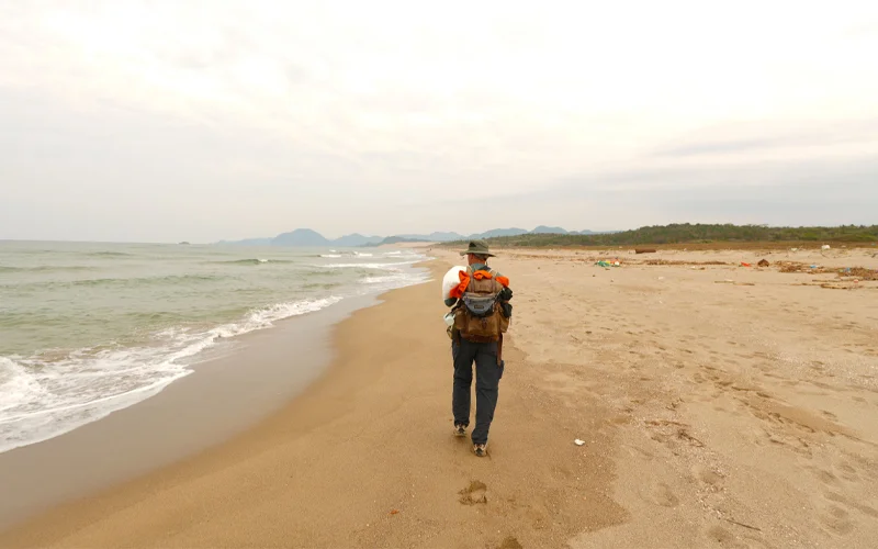 Explorer and Pulitzer Prize-winning writer Paul Salopek walks a beach on Japan’s western coastline as part of a planned journey that will continue through the Americas and end at Tierra del Fuego.