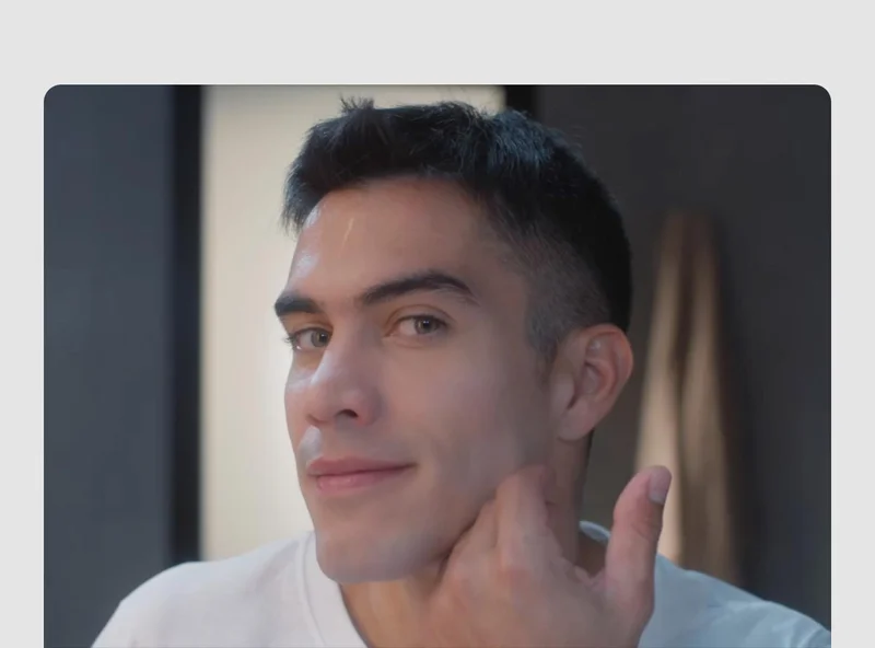Young man touching his freshly shaven face