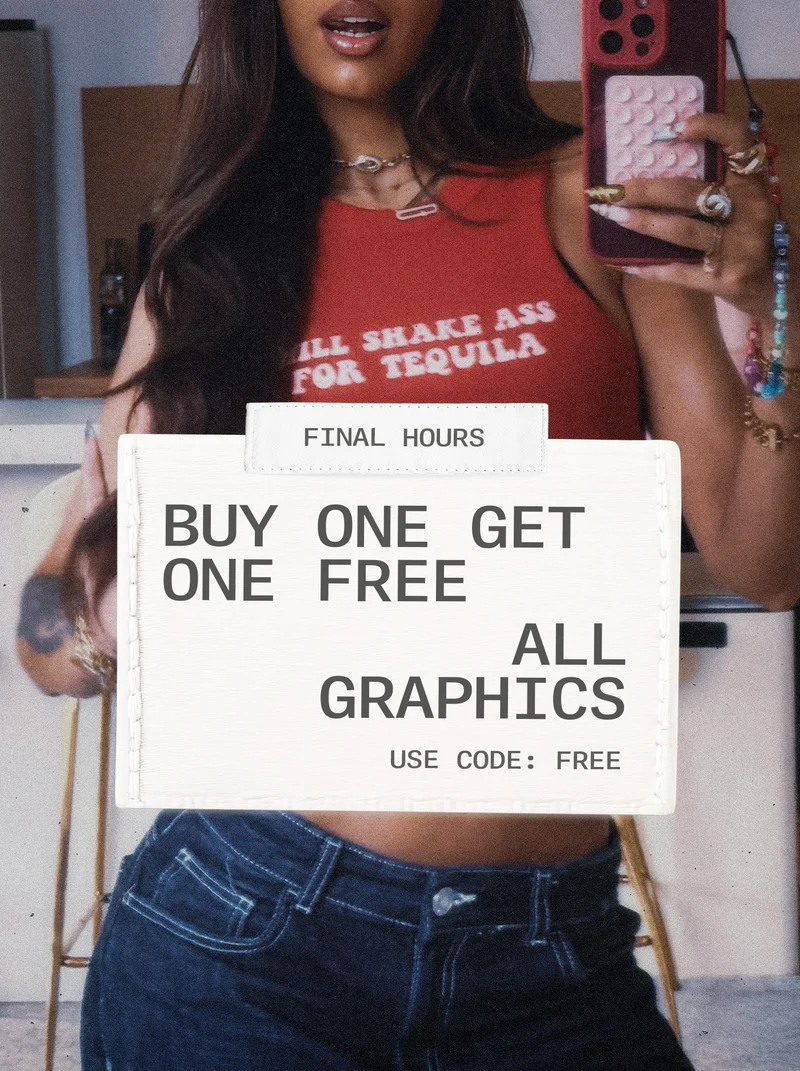 Woman in red graphic tank top and dark jeans holds phone. White sign announces "FINAL HOURS: Buy One Get One Free All Graphics. Use code: FREE."