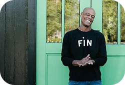 A man wearing a FiN black Claire V sweatshirt.