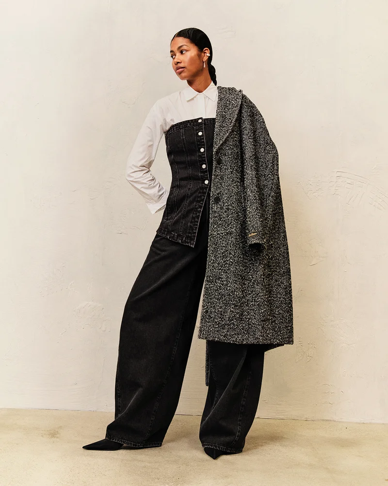 PERSON IN BAGGY JEANS AND COAT