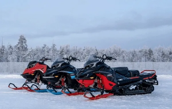 Lynx snowmobiles parked side by side.