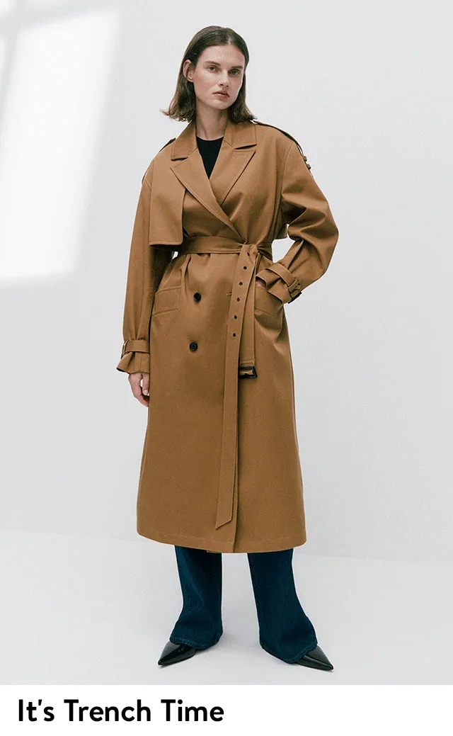 A woman wearing a tan trench coat.