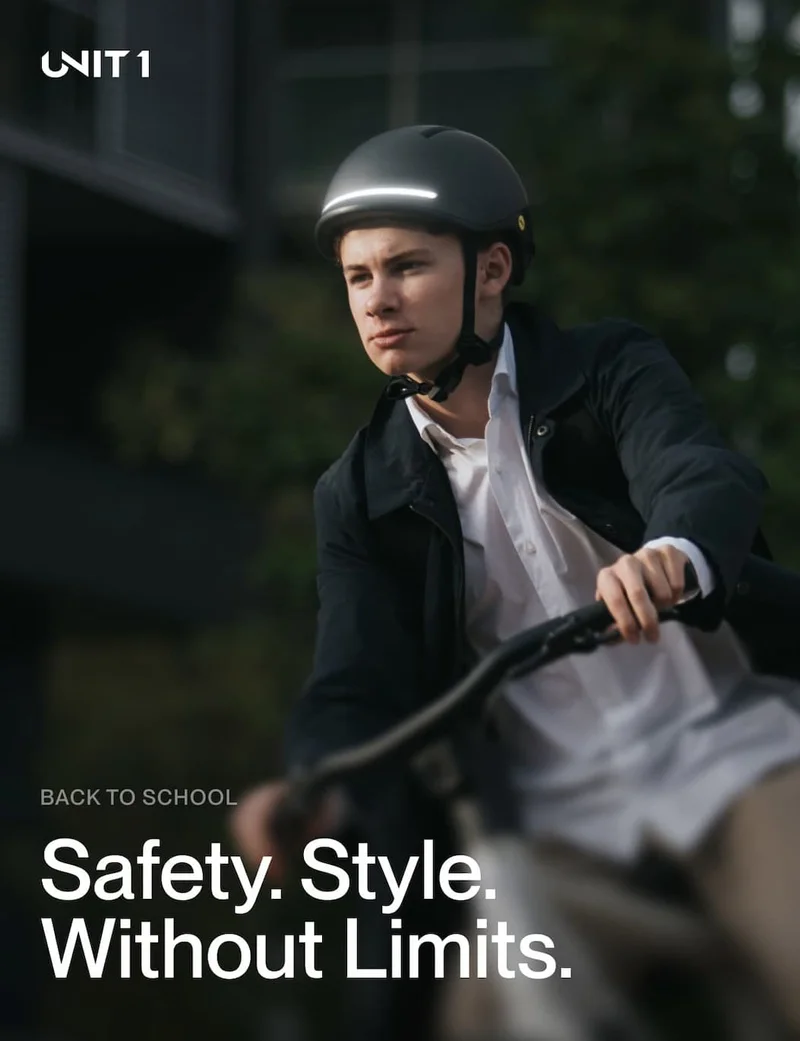 Cyclist wearing UNIT 1 smart helmet riding through the city – safety, style, and performance combined.