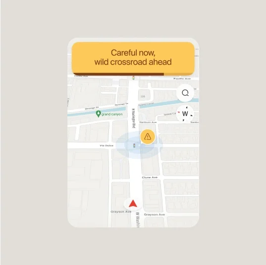 A map interface with a yellow notification bar at the top reading, “Careful now, wild crossroad ahead,” and a highlighted warning icon over a blue zone on the map.