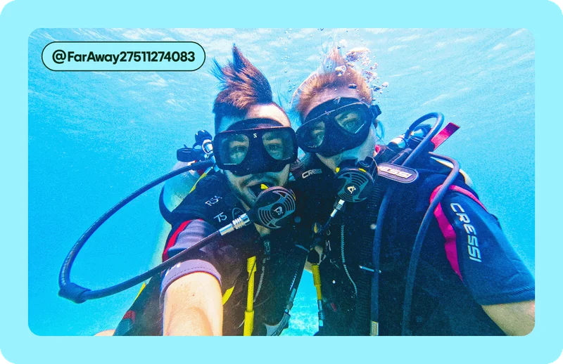 Image Description: Two people posing for a photo while scuba diving.