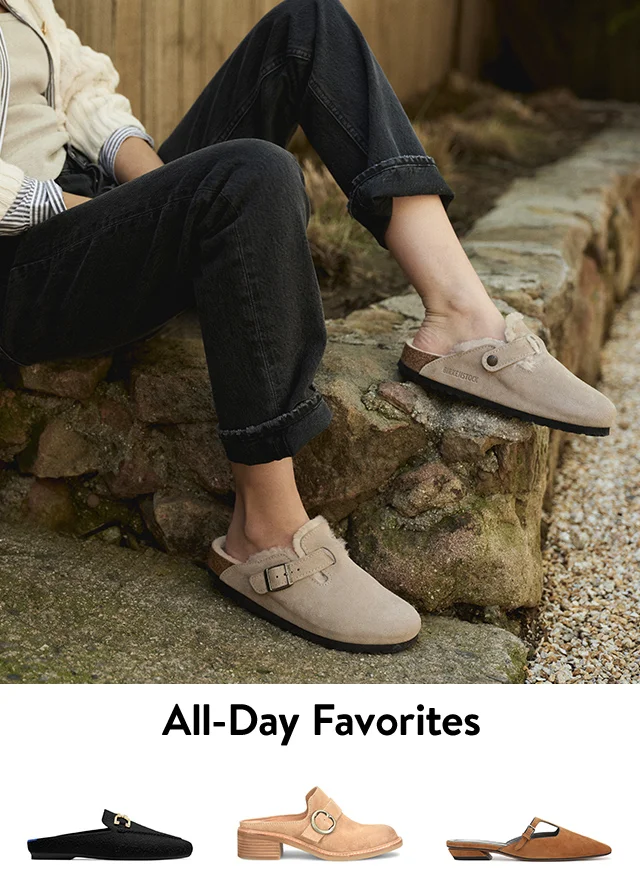 A woman wearing Birkenstock clogs. Black, tan and brown mules.