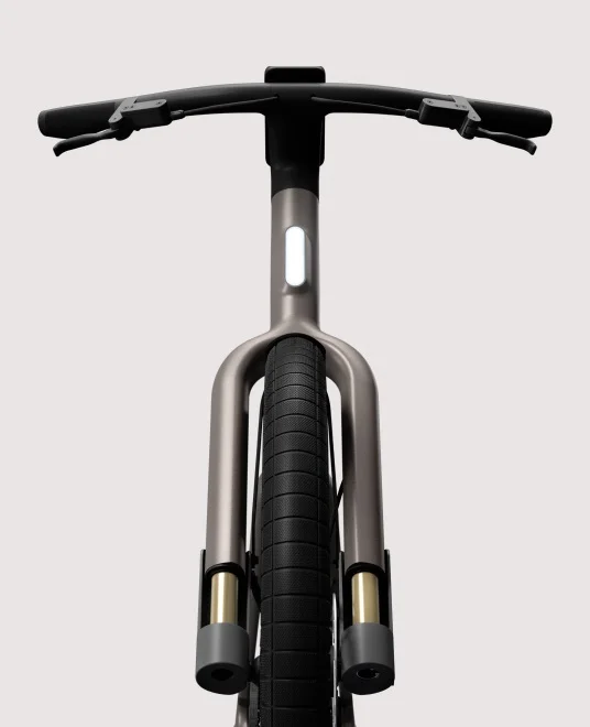 A render. Rear angled view of a Cowboy Cross ST e-bike with a cargo rack and integrated rear light.
