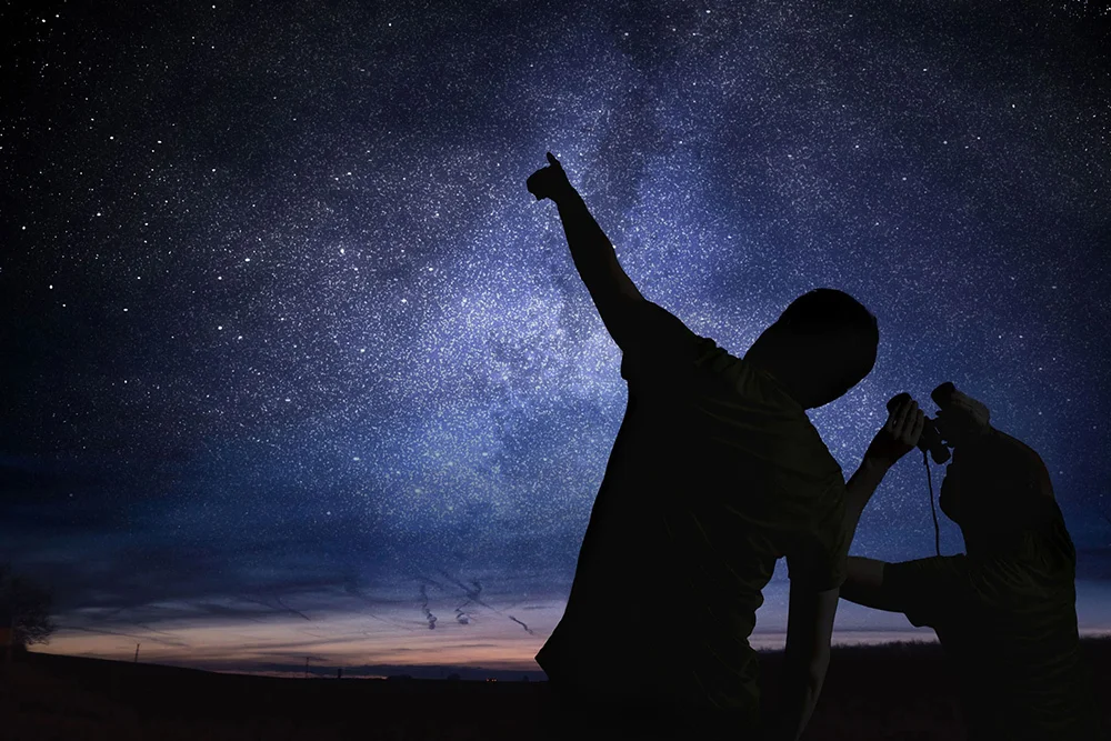 Two people gazing at the night sky