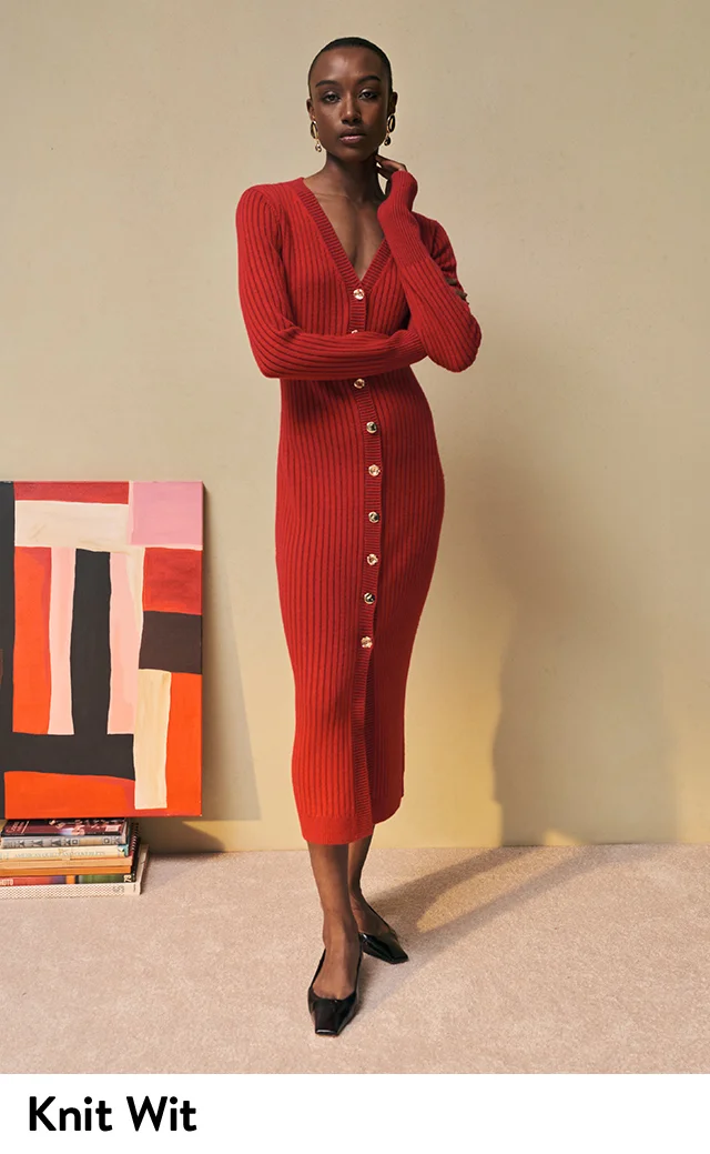 A woman wearing a red sweater dress.