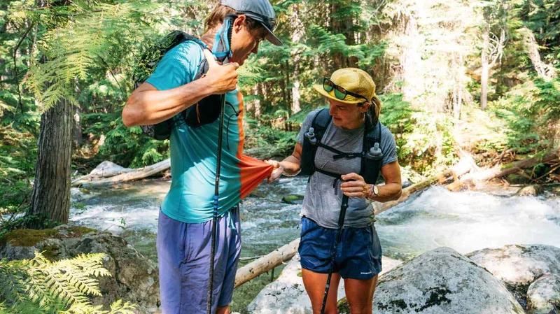 One person looking at another person’s shirt out on a trail.