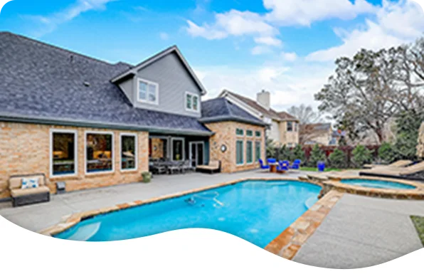 Waterfront home with pool, sun loungers, and private docks overlooking a calm lake.