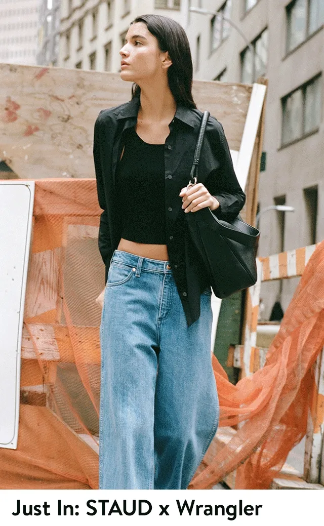 A woman wearing a black top with wide-leg jeans. A woman wearing a white sweater, white jacket and white wide-leg jeans.