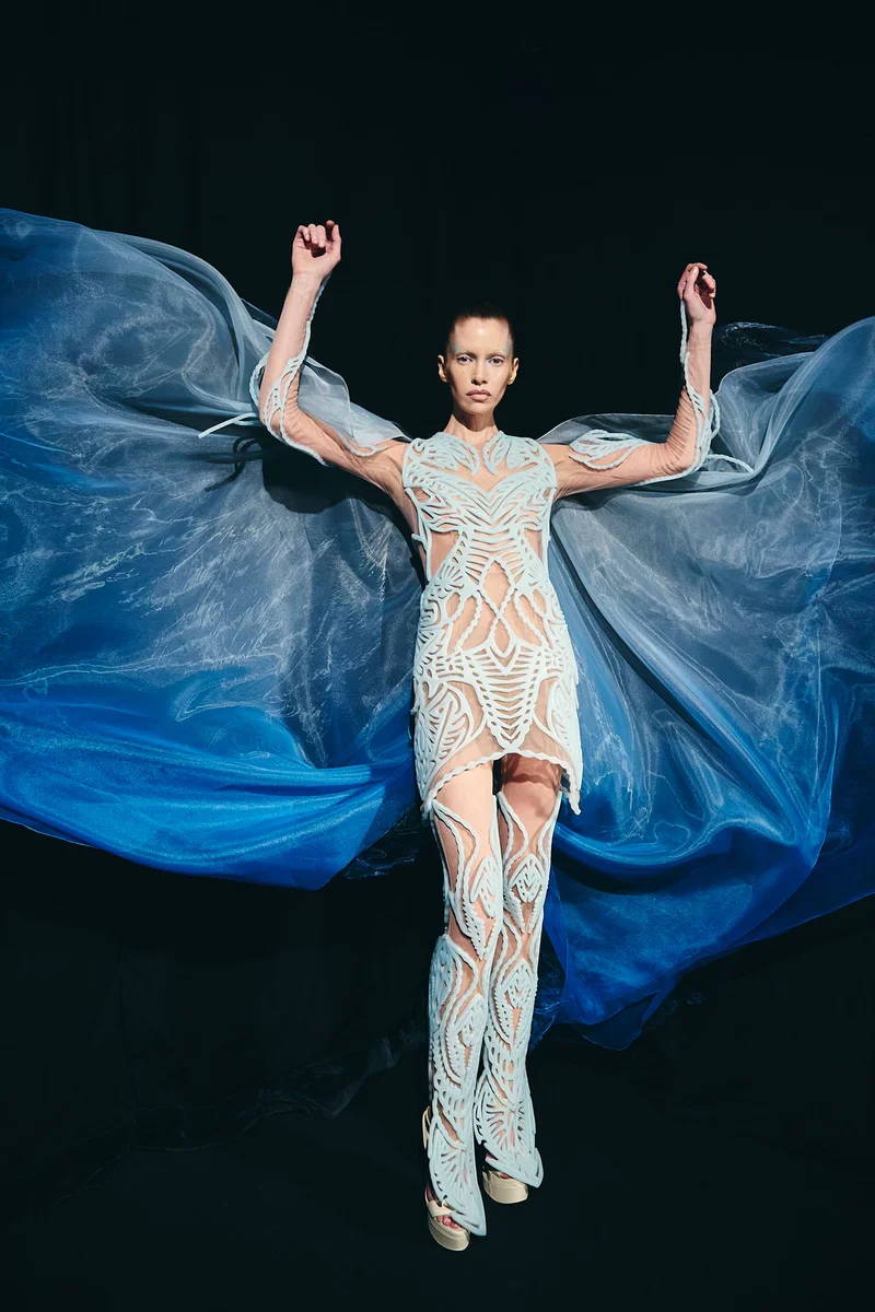 A model wearing a flowing blue dress