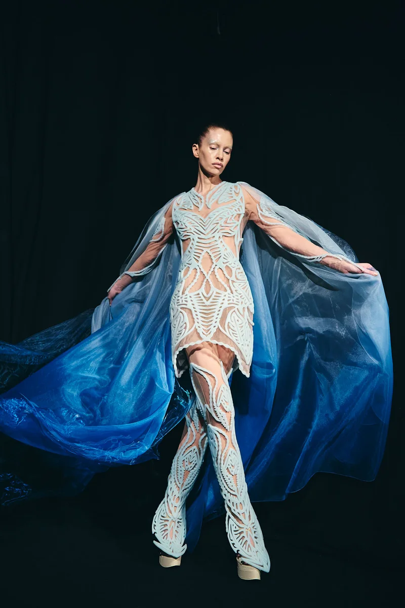 A model wearing a flowing blue dress