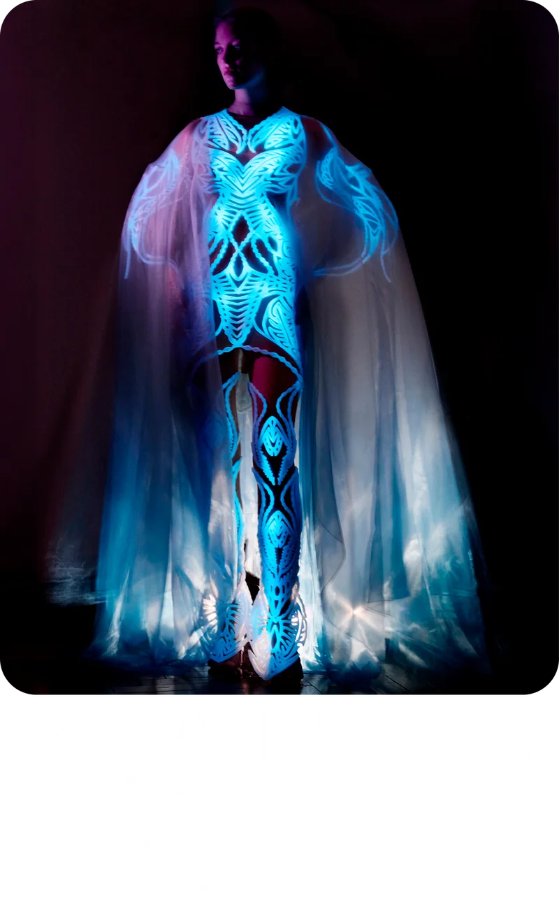 A model wearing a glowing blue dress