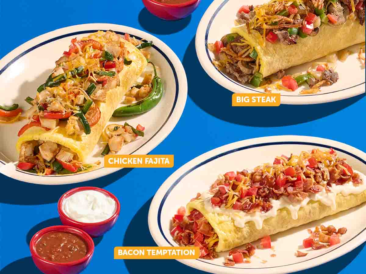 A selection of IHOP Stuffed and Stacked Omelettes on plates on a blue surface. Omelettes features are the Chicken Fajita, Big Steak, and Bacon Temptation.