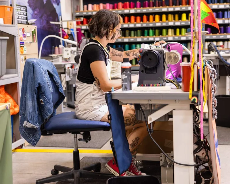 A person sitting at a sewing machine.